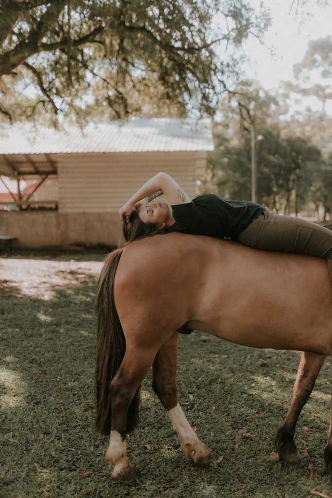 femme détendue couchée sur le dos d'un cheval 